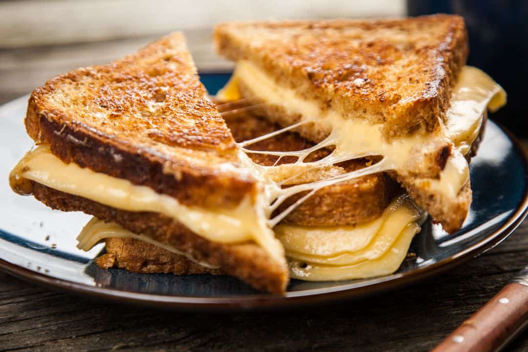 Raclette cheese melted over grilled sandwiches